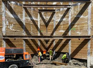 Crew installing shoring for the Green Lake Apartments building